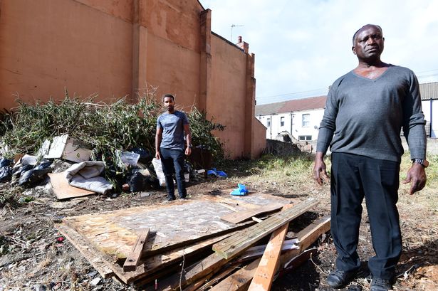 Nelson Shardey (front),and his son Jacob on derelict land that's been abandoned near their home