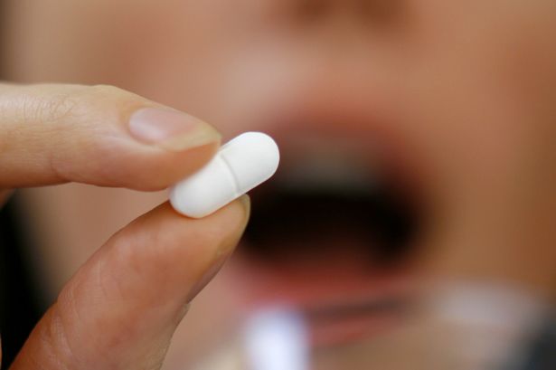 A person taking a tablet