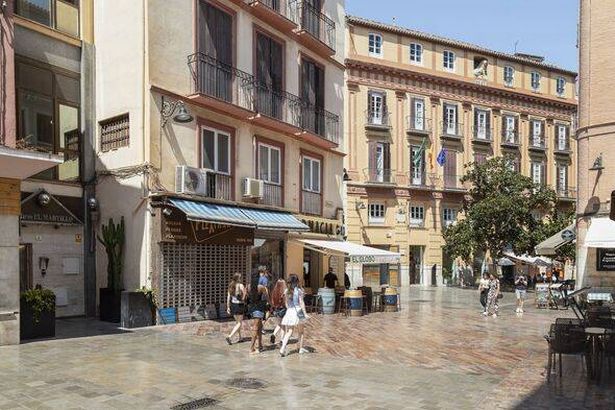 People stroll through the historic old town of Malaga.