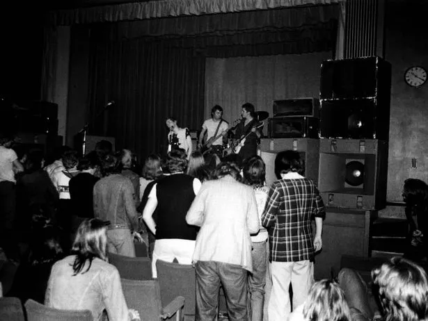 The Sex Pistols performing on stage at the Free Trade Hall in June 1976