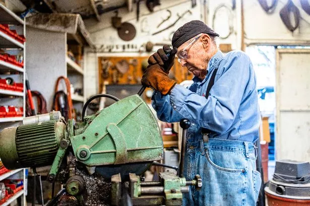 A 94 year old WW2 Navy Vet farmer working in his workshop