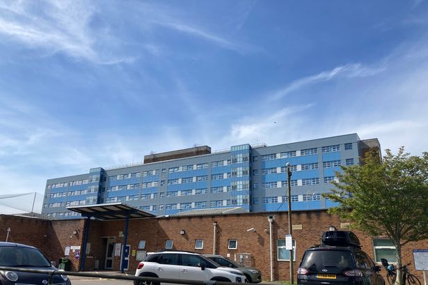 A hospital with cars parked outside
