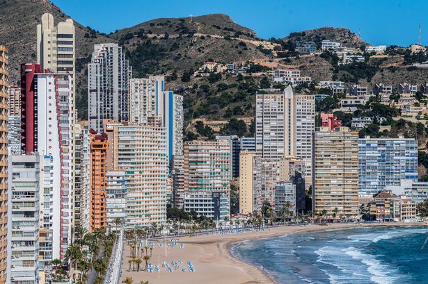 Apartment towers sit along the promenade of the Playa de Levante Beach in Benidorm, Spain