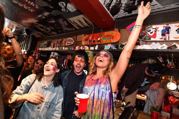 Beatles fans in costume attempt at Crazy Pedro's on July 29, 2018