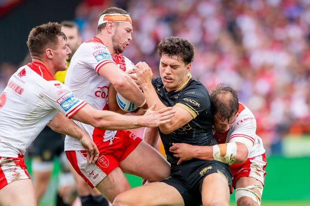 Hull FC's Lewis Martin is tackled by Hull KR's James Batchelor.