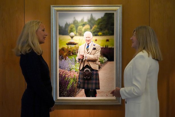 Photographer Millie Pilkington(L), alongside Presiding Officer, the Rt Hon Alison Johnstone MSP after The Princess Royal unveiled a new portrait of King Charles III