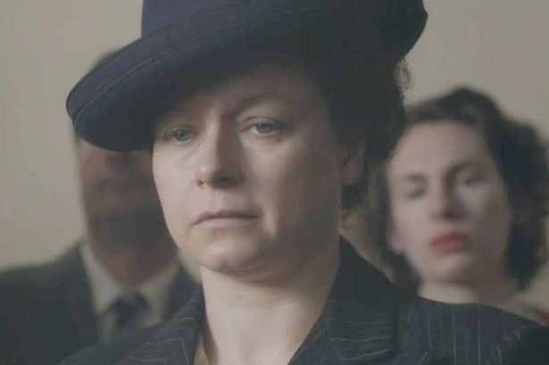 A woman in black looks sad