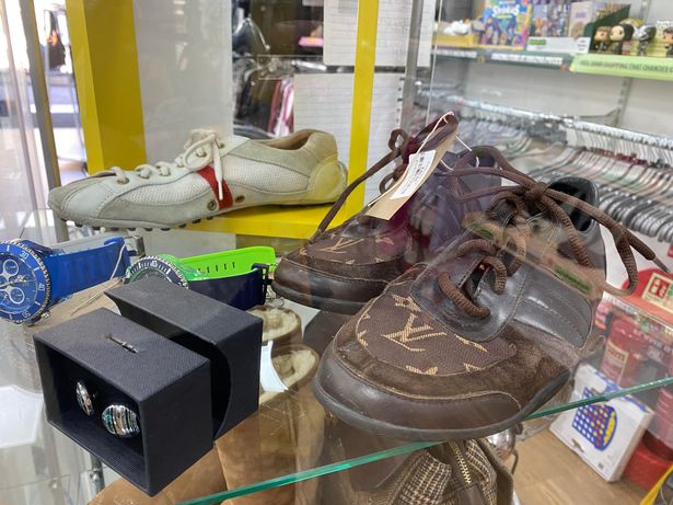 The white Prada trainers and the brown Louis Vuitton pair 