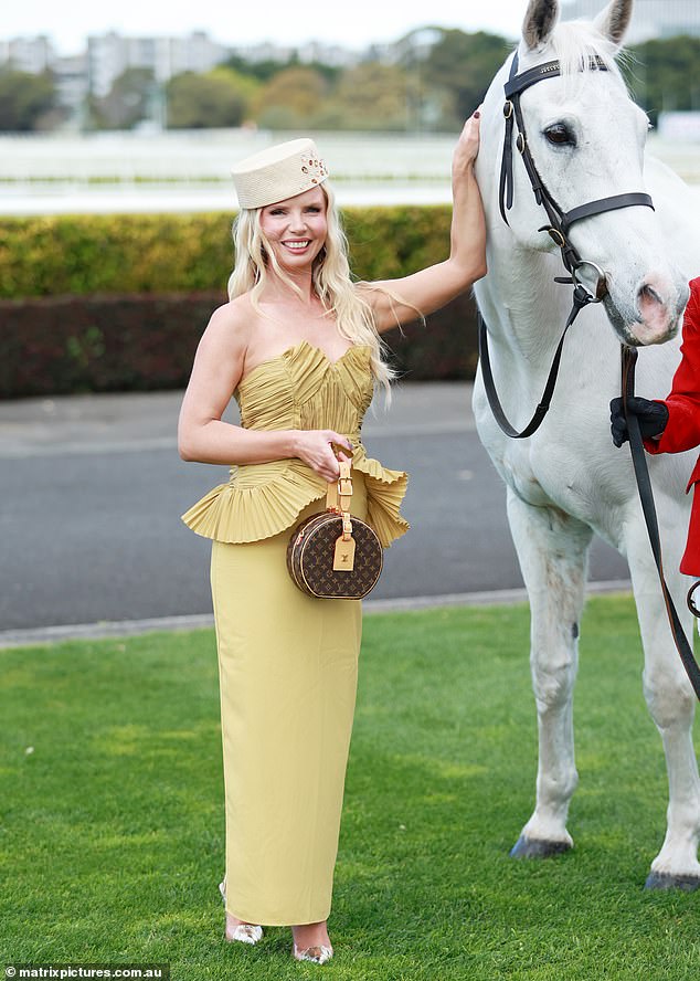 Hat designer Stacey Hemera Roberts showed off her figure in mustard-coloured strapless dress