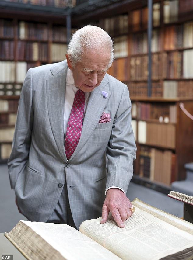 His Majesty appeared fascinated by one of the historic books, which he paid close attention to during his visit