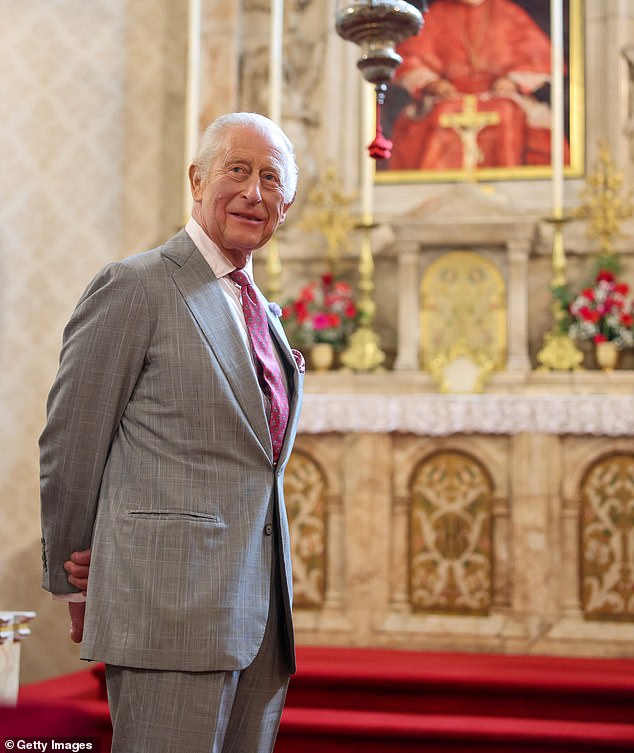Charles was dressed in a grey suit complete with a red patterned tie for the occasion