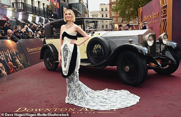She posed against the iconic Downton Abbey car