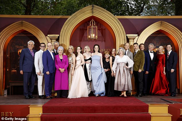 The cast of Downton Abbey: The Grand Finale, which releases September 12, pictured L-R: Jim Carter, Allen Leech, Kevin Doyle, Douglas Reith, Penelope Wilton, Raquel Cassidy, Sophie McShera, Laura Carmichael, Michelle Dockery, Lesley Nicol, Joanne Froggatt, Phyllis Logan, Harry Hadden-Paton, Rob James-Collier, Dominic West, Hugh Bonneville, Joely Richardson and Arty Froushan