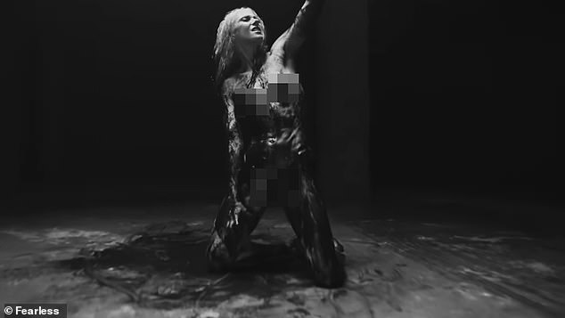 In it, Taylor writhes on the floor while showcasing the sinewy curves of her slim 5ft8in figure