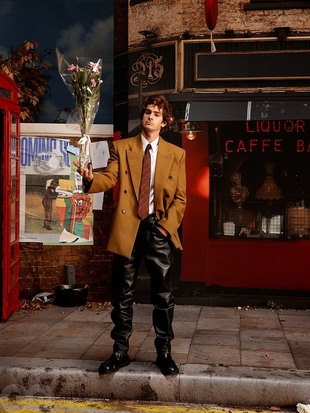 Actor Andrew Garfield suited up in a Saint Laurent blazer, tie and leather trousers