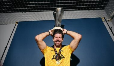 Fraser Forster poses with the Europa League trophy after last season's Tottenham triumph