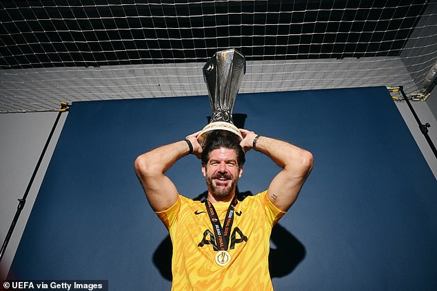 Fraser Forster poses with the Europa League trophy after last season's Tottenham triumph