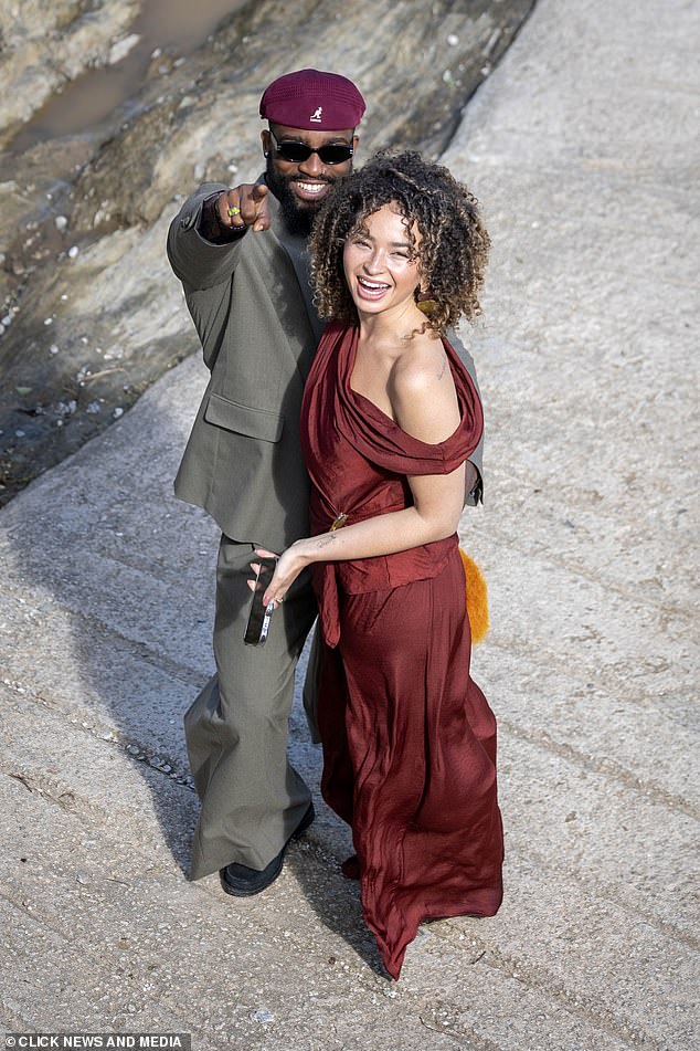 Ella meanwhile made a statement in a burgundy gown with ruching and an off-the-shoulder detail while her hair was worn loose and natural