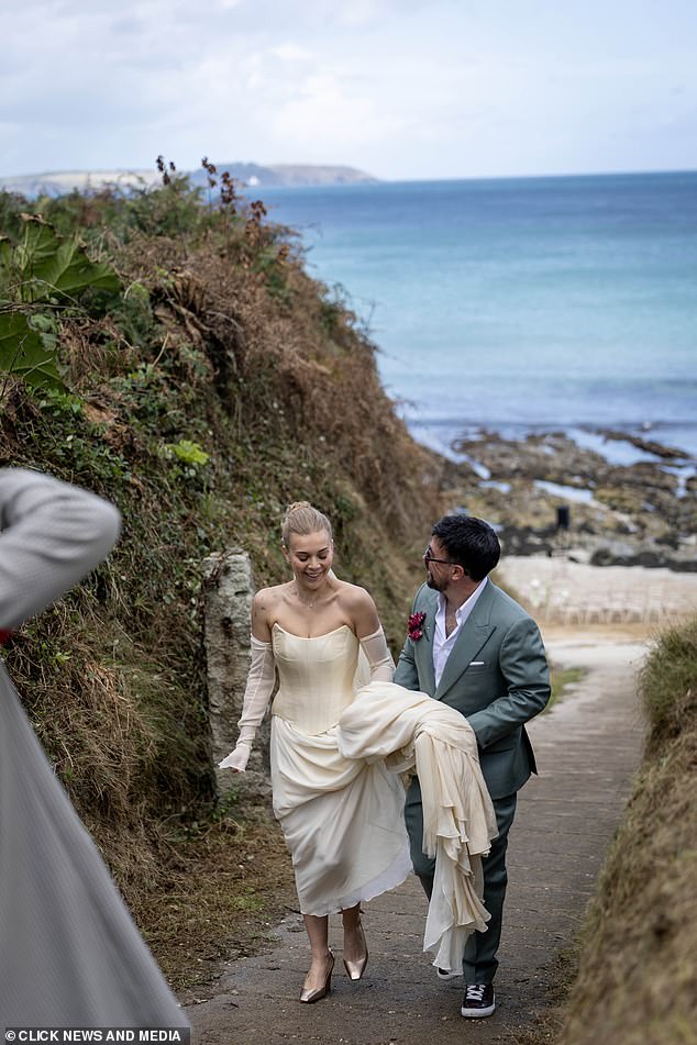 Ever the gent, Charlie held his wife's gown as they sashayed away from the ceremony