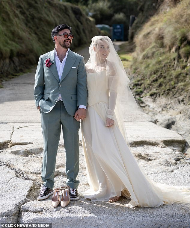 The Crazy What Love Can Do songstress, 31, looked sensational in a corseted gown with long gloves, a billowing skirt and an elegant veil, however she was forced to remove her shoes in the sand while Charlie opted for trainers