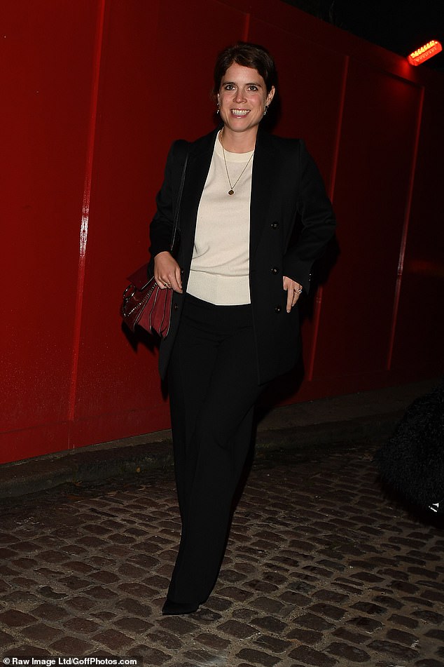 Princess Eugenie, 35, looked effortlessly stylish in a cream jumper and black slacks, adding a pop of colour with a scarlet handbag