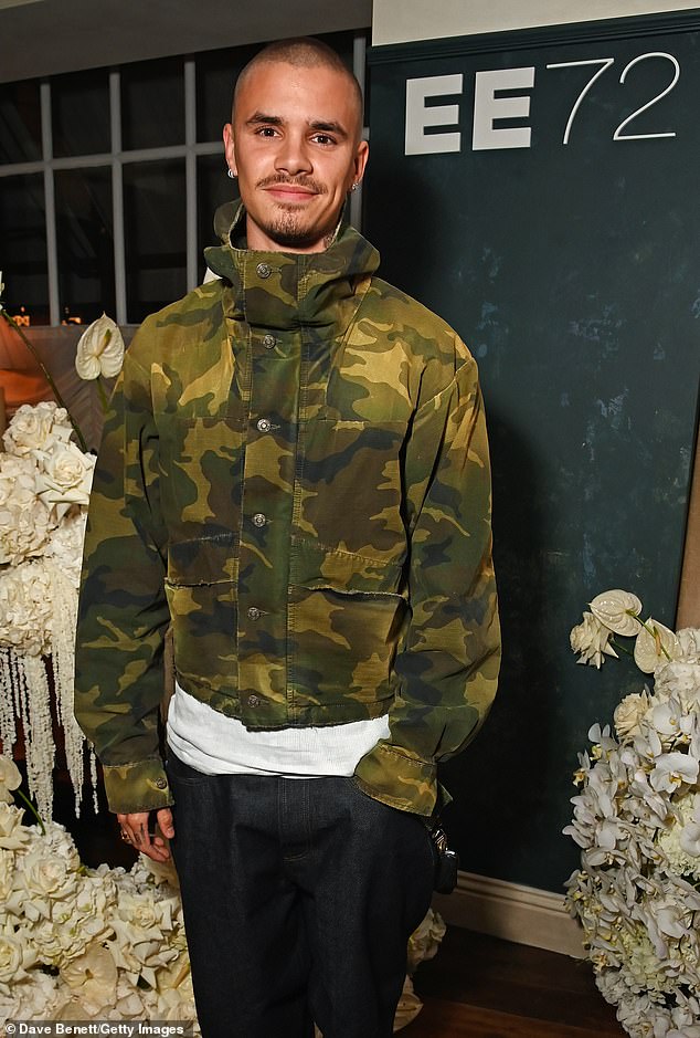 The son of David and Victoria Beckham cut a casual figure in a camo jacket and jeans