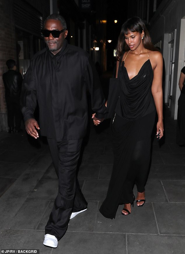 Idris was the epitome of cool in a black shirt and trousers with white trainers