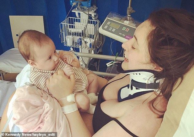 Hayley Black wearing a protective neck brace in the hospital with her new born baby Amelia