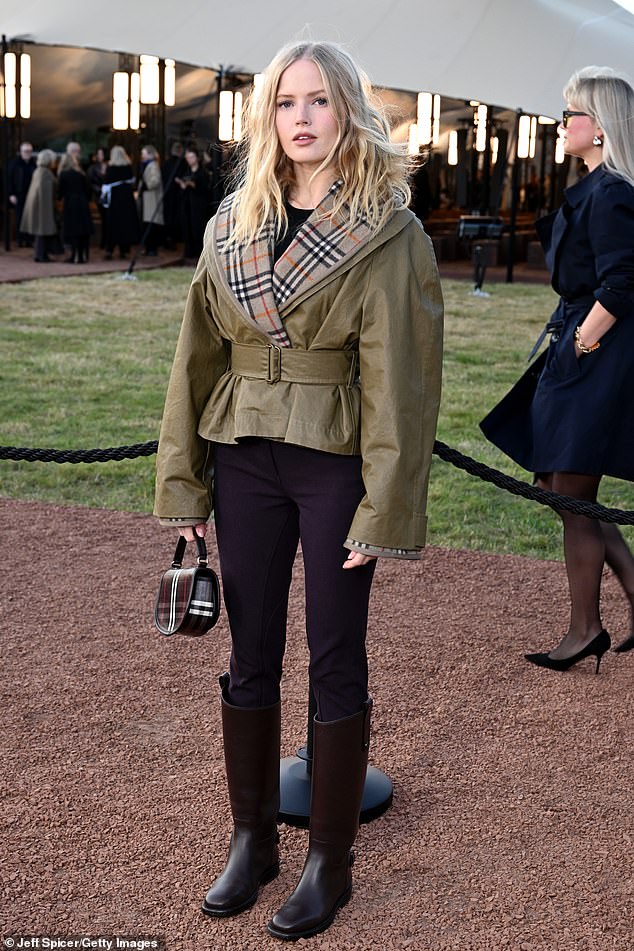 Ellie Bamber also opted for the famous Burberry Check, sporting a belted khaki leather jacket with the tartan print on the lapels and hem