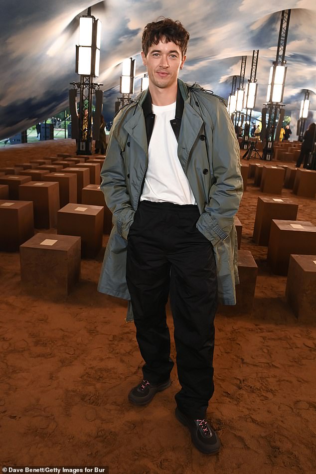 Actor Tom Blythe looked effortlessly handsome in a plain white T-shirt and black trousers under a cool grey coat