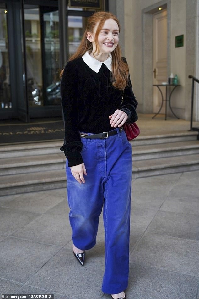 The actress was dressed in wide-legged jeans, a black jumper and a white collared shirt, accessorising with pointed-toe heels