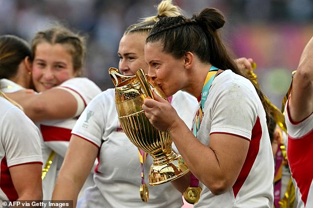 It is believed Saturday's accolade for the women's rugby team, won on home turf, could do the same thing for the sport as the Lionesses' Euros win in 2022 did for football. Pictured: England's lock Abbie Ward kisses the winners trophy after Saturday's victory
