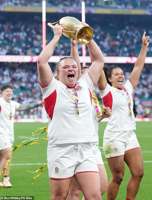 England's Sarah Bern lifts the trophy as she celebrates with teammates after winning the Women's Rugby World Cup final