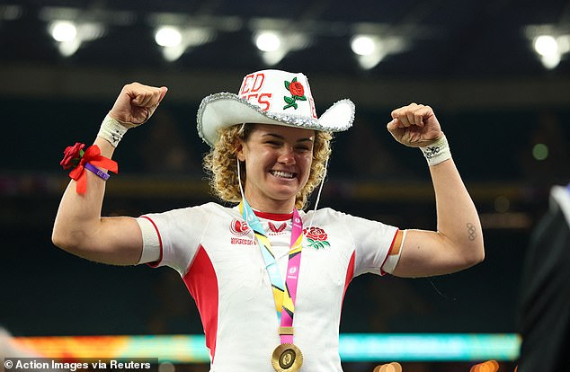 Kildunne celebrates with her medal and a hat after winning the final