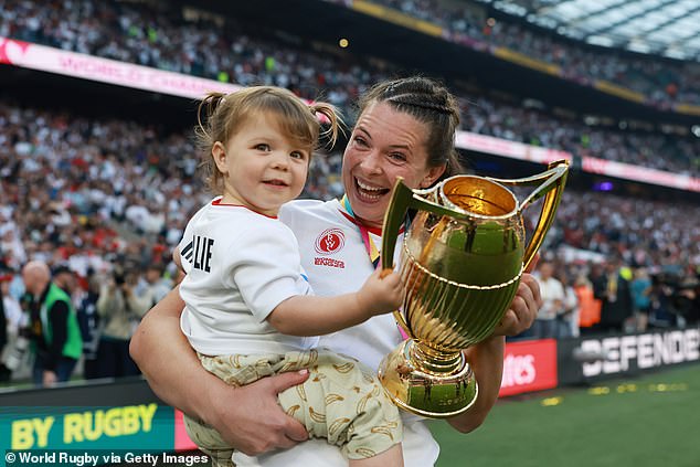 Abbie Ward of England holds the Women's World Cup Trophy with her daughter Hallie