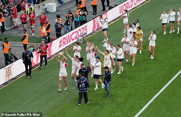 England's Zoe Aldcroft lifts the Women's Rugby World Cup trophy as the players parade around the stadium