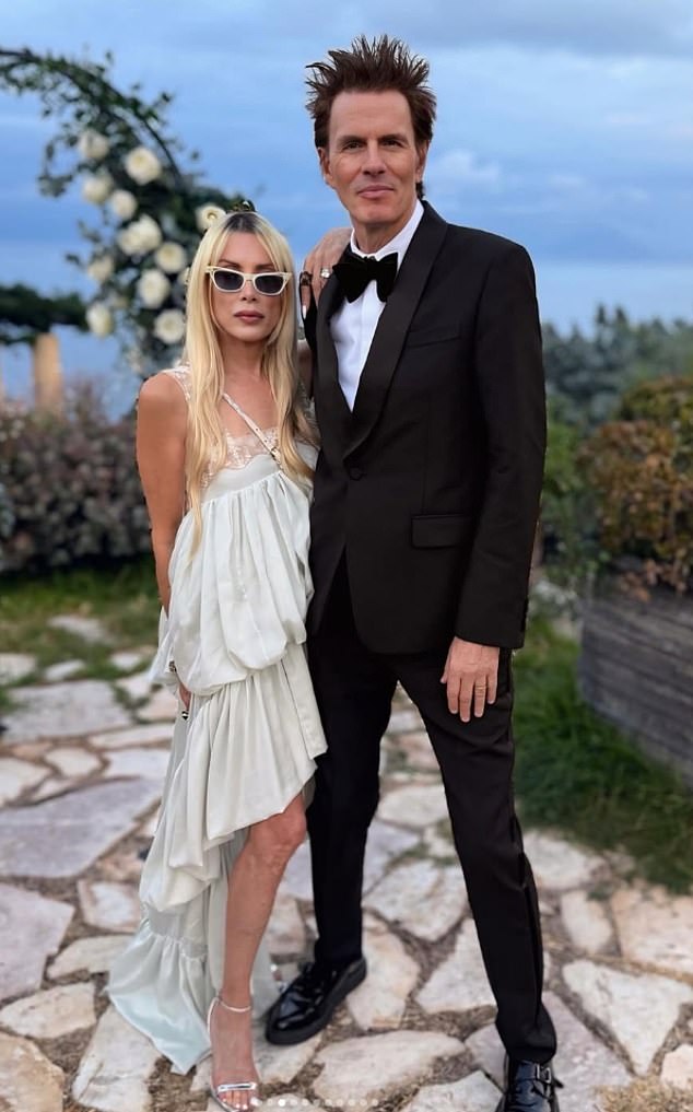 Another captured former actress Gela, who married John in 1999, looking impossibly fresh-faced as she posed next to her husband in a loose-fitted off-white dress