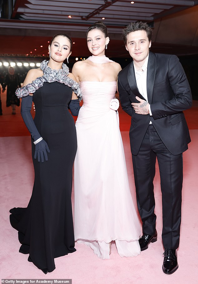 Brooklyn and Nicola's couples shoot comes after the reason they didn't attend Selena Gomez and Benny Blanco's wedding was revealed (pictured with Selena in 2023)