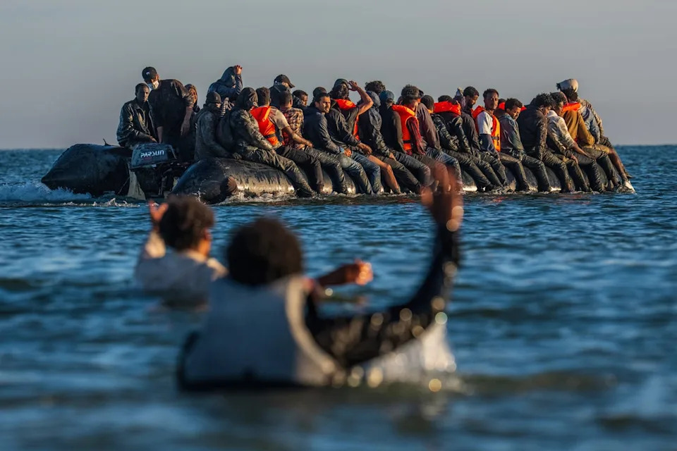 People try to board a dinghy off the coast of Gravelines, France (Getty)