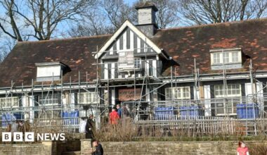 The Rose Garden Café in Graves Park, Sheffield, with customers queuing out of the door. Scaffolding surrounds the Tudor-style building.
