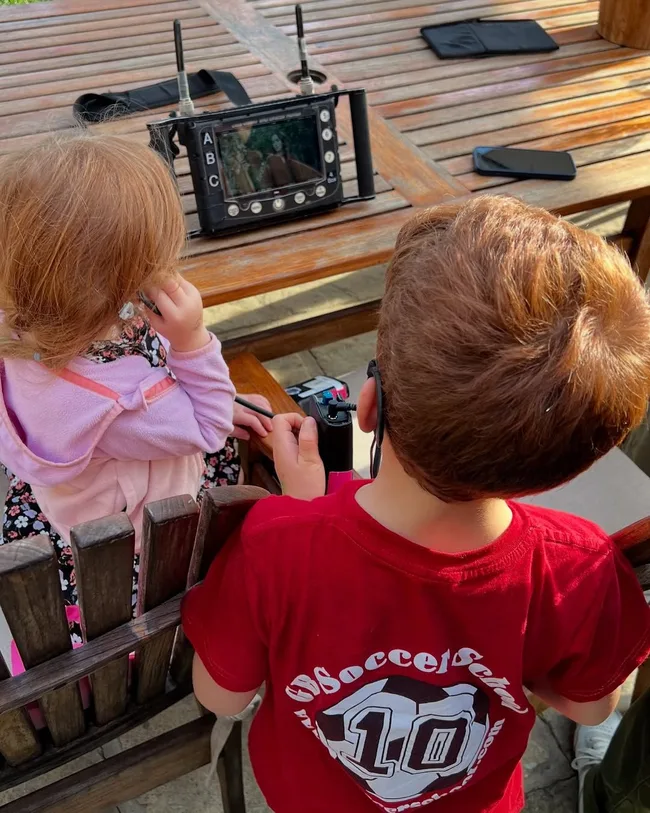prince harry and meghan's children archie and lilibet watch meghan on a director's screen as she film's her show with love, meghan