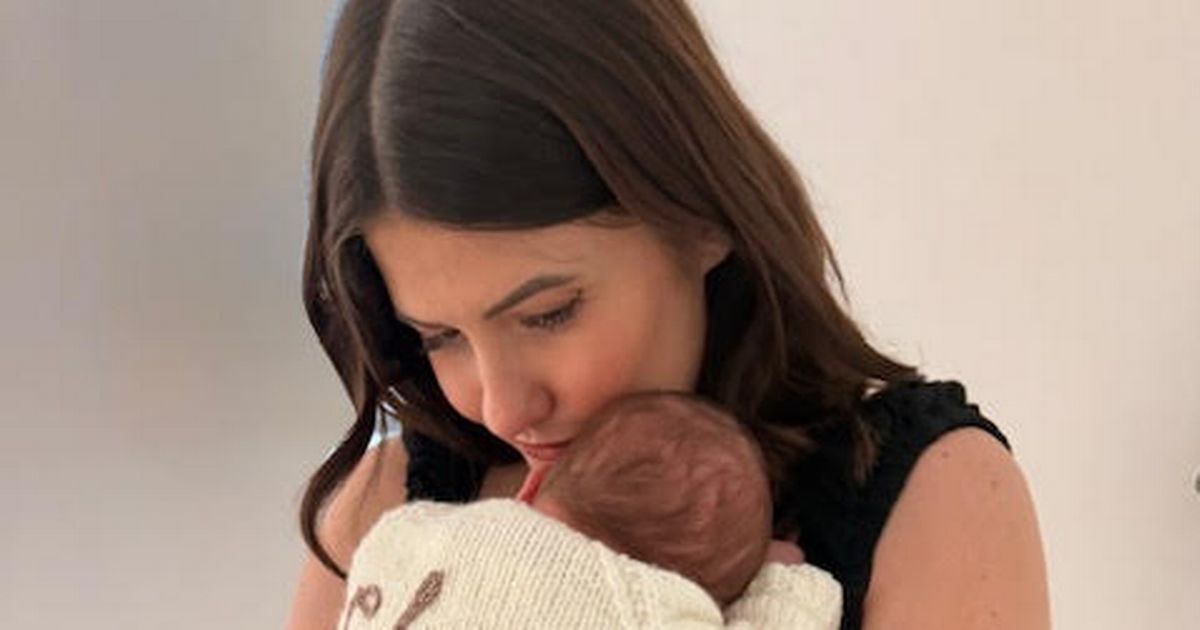 Aimee cuddles baby Charli