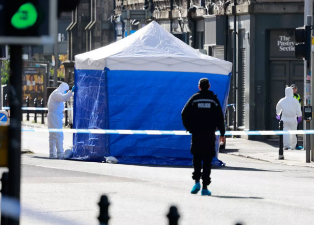 Forensic officers next to a tent within the cordon
