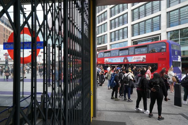 People waiting bus outside Victoria Station, central London