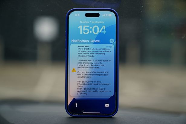 A mobile phone sounds with an alarm during a national emergency alert 