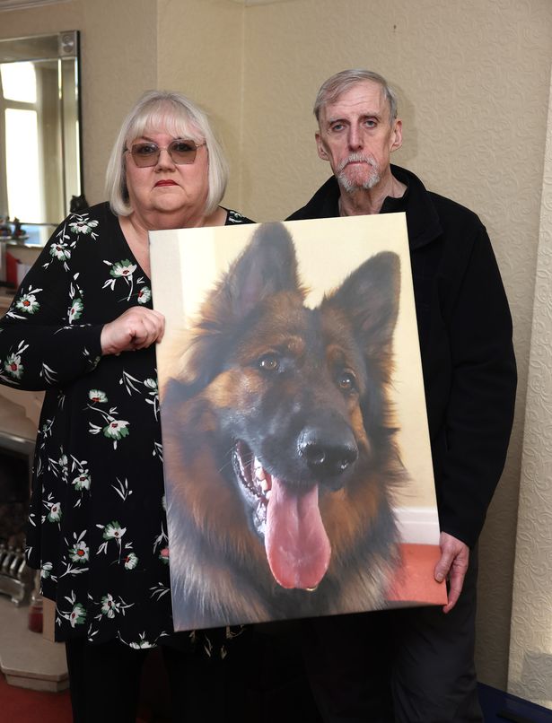Lynn and Terry Maher with a picture of Shadow