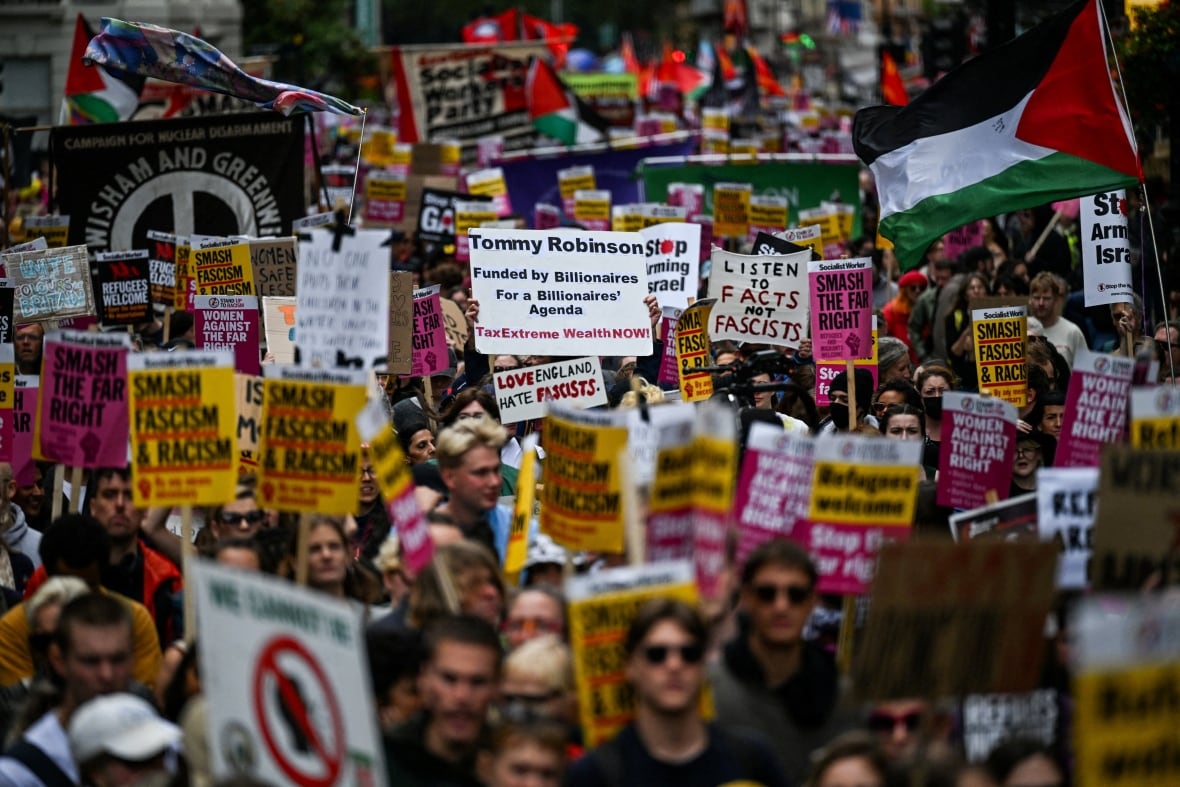 Protesters hold up signs during a march.