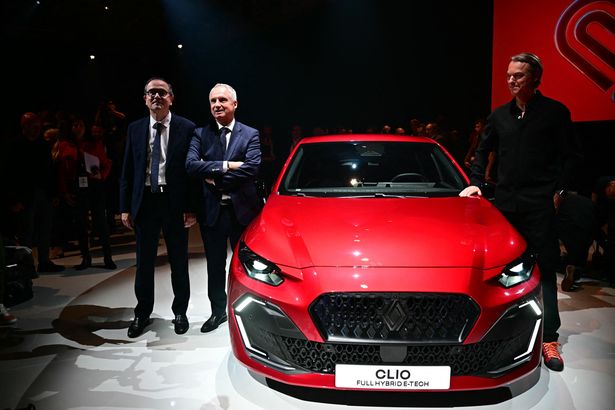 Newly appointed CEO of French car maker Renault Group Francois Provost (2nd L) and Chief Growth Officer of Renault Group and CEO of Renault Brand Fabrice Cambolive (L) pose near the unveiled new Clio car at the International Motor Show IAA on September 8, 2025, in Munich, southern Germany