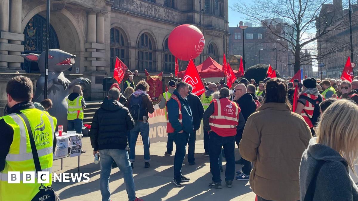 The demo outside Sheffield Town Hall, with people waving red Unite banners, balloons and flags.