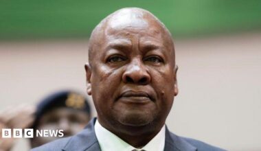 John Mahama, in a suit, is standing and looking serious at an event in Accra, Ghana, in March 2025